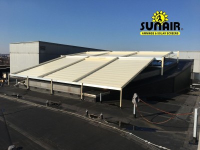 A white pegola awning canopy over a commercial area